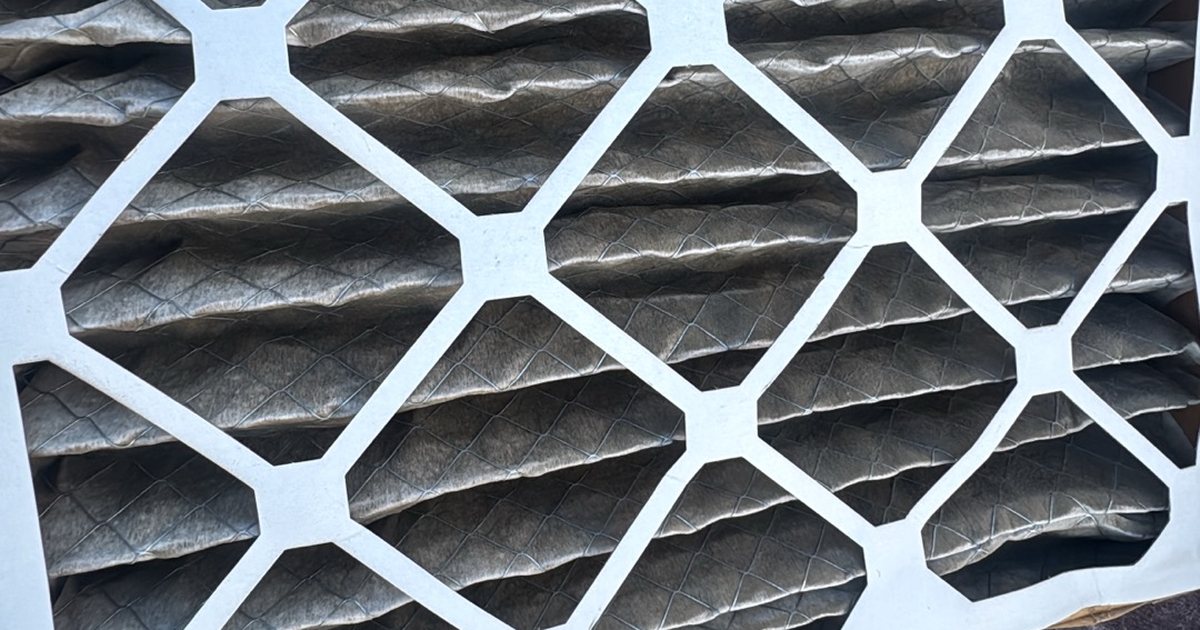 Dirty pleated HVAC air filters close up, a sign it is time to change the air filter