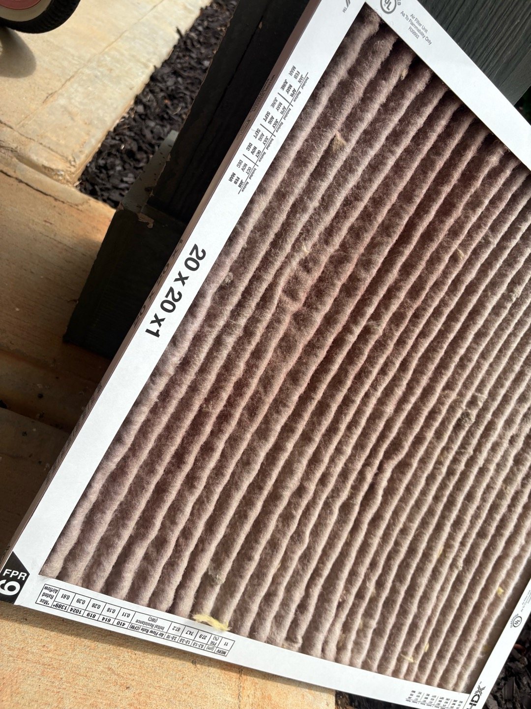 Dirty 20x20x1 pleated AC air filter clogged with dust, a common reason an AC runs but doesn't cool