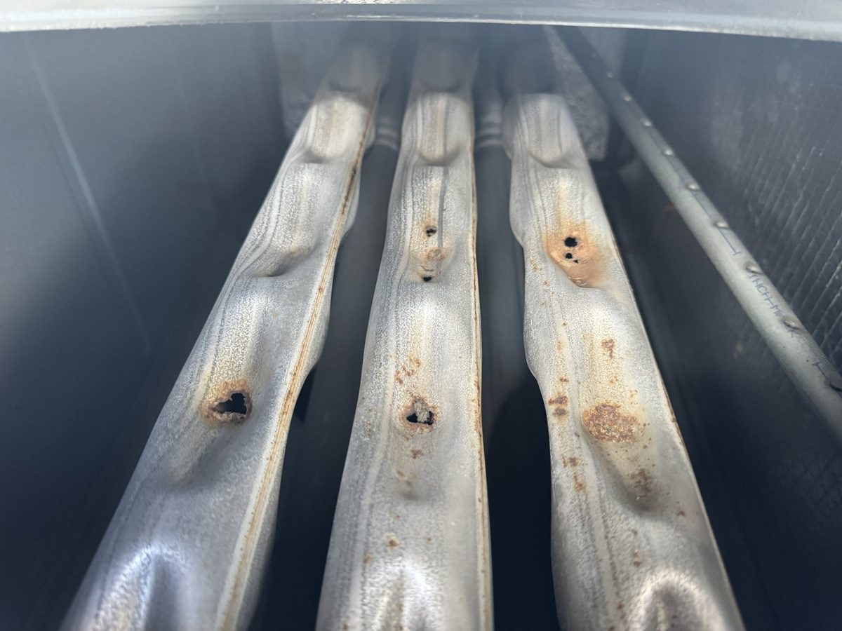Rusted gas furnace heat exchanger cells with several holes rusted through the metal